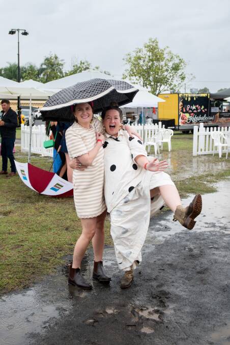  Wet weather at the Dalby Picnic Race Day could not dampen the spirits of Emily Nugent and Meg Chandler. Picture::Ange Stirling Photography