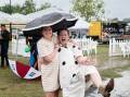  Wet weather at the Dalby Picnic Race Day could not dampen the spirits of Emily Nugent and Meg Chandler. Picture::Ange Stirling Photography
