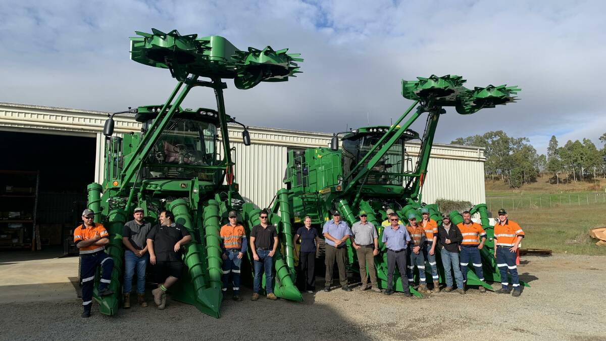 RDO Equipment Mackay staff with two John Deere CH960 two row cane harvesters before they head out the gate to their new owners. Picture supplied by RDO Equipment.