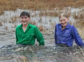 Lara Farmer, Mt Elsa, Canoona, with her cousin, Jarvis Collins, couldn't resist jumping in "a puddle" after 112 mm fell at Mt Elsa in 30 hours. Picture: Claire Farmer