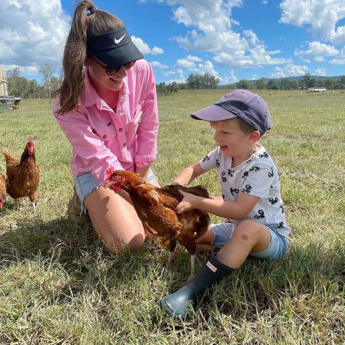 Taylah Christoffel farm manager at Grazing Girls with Austin Conwell checking one the 4000 pasture-raised chickens who's eggs are in high demand due to shortages cuased by avian influenza. Picture: Supplied