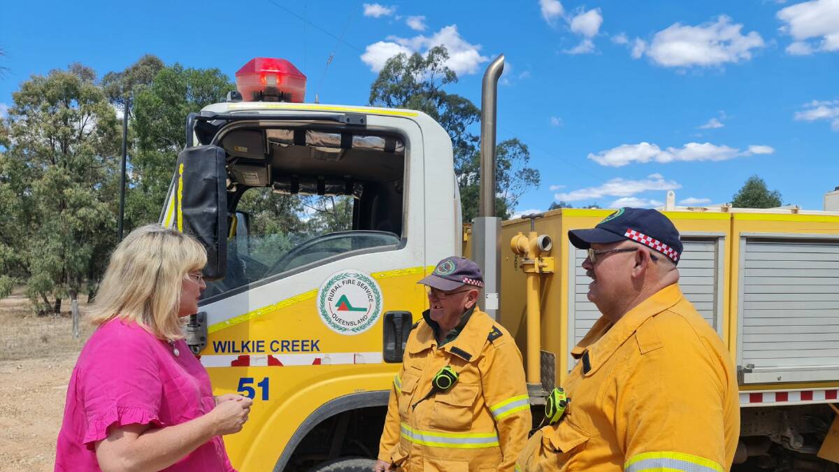 Warrego MP Ann Leahy speaks with Wilkie Creek volunteers, hearing they were thankful for the cleared area beside the wild dog barrier fence, which stopped one fire in its tracks.