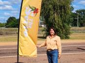 Yvonne Schaefer with the new highway sign for The Servo at Pentland. Picture: Supplied
