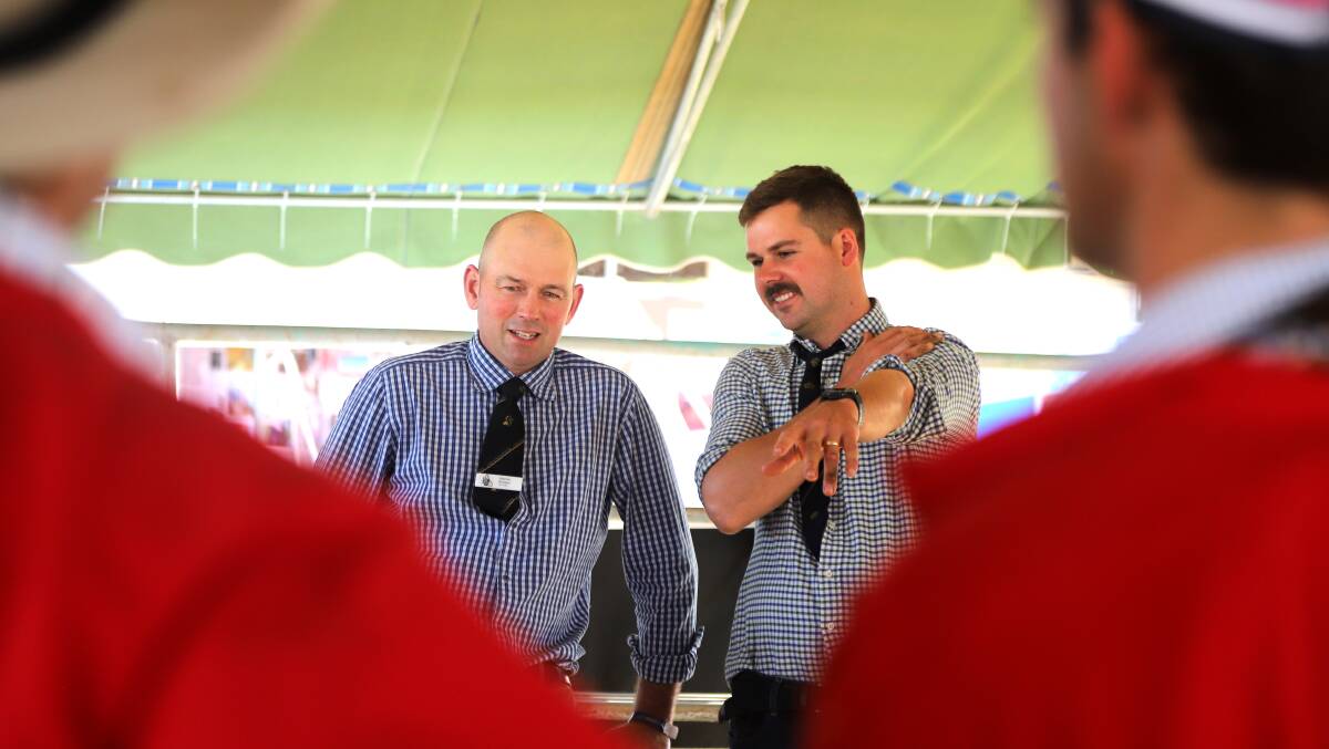 Queensland State Sheep Show judges Warren Russell and Daniel Rogers debate over a decision. Picture: Sally Gall