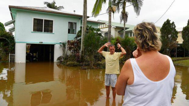 Tracey (right) and Laurie Batshaw (left) in front of their house in flooded Bright street in Lismore.  Photo: Kate Geraghty