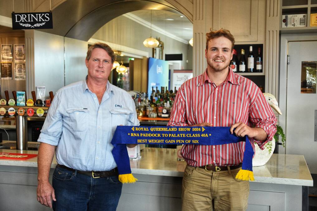 JBS's northern division general manager of livestock, Edwin Cooke, with Ash Morgan of The Grove Shorthorns, Condamine, accepted the award for his family's winning pen of six HGP free steers. Picture: Ben Harden 