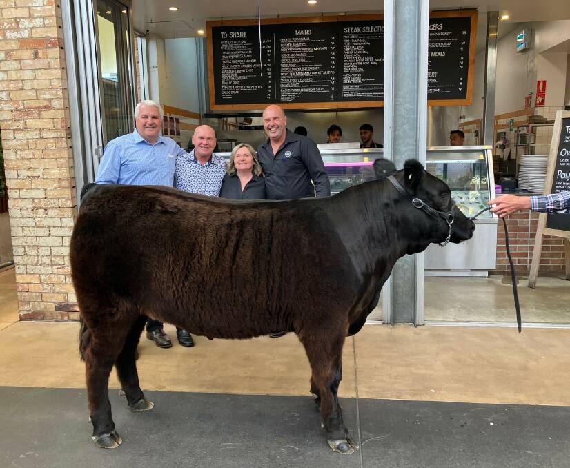 Terry Nolan of Nolan Meats, Alfie Langer, Sue McKinnis and Mike Rodgers of Breakfast Creek, with the charity black Limousin steer which sold for $35,000. Picture supplied. 