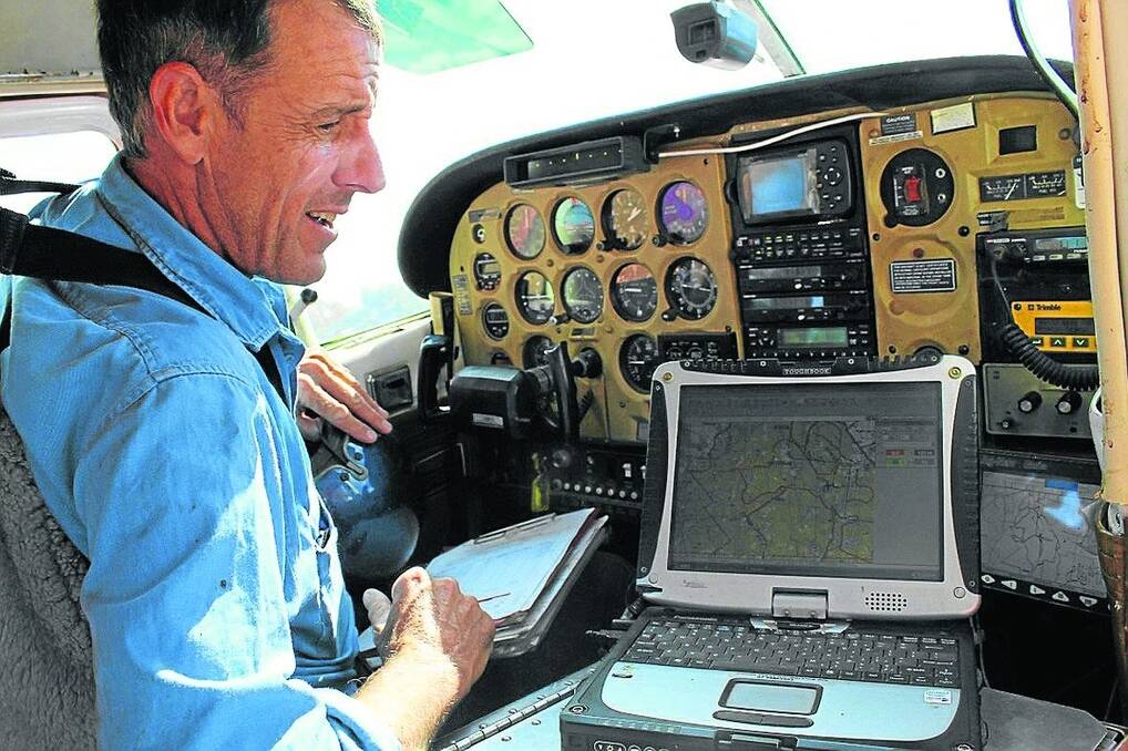 Aerial baiting operator Alan MacDonald has a large range of mapping technology at his fingertips as he puts baits out, including previous flight paths, so that he can deliver meat according to instructions (INSET).