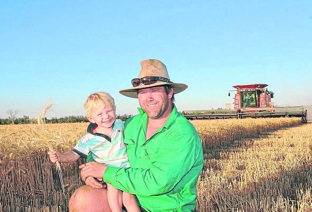 Darling Downs farmer Scott Moore and his son, Charlie, harvest their high-yielding, high-protein crop of wheat on their Macalister farm, Cable Hole.  Picture: SARAH COULTON.