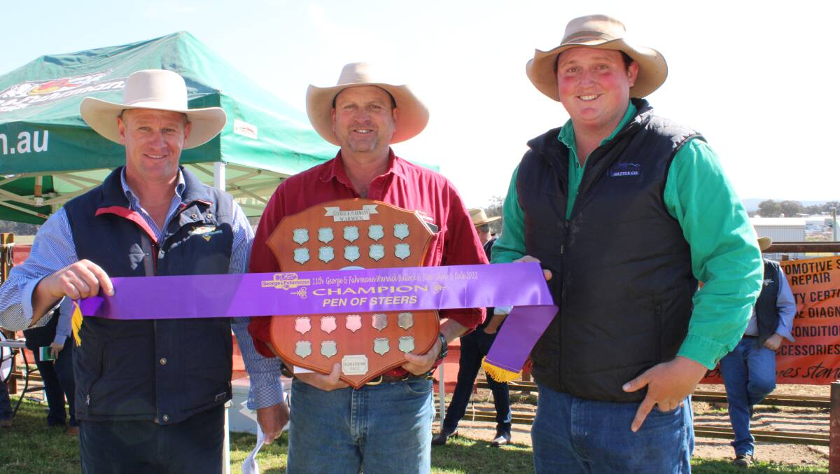 Matthew Grayson, George and Fuhrmann, Warwick presents Haydn Lamb, and Brenden Lamb of Wickham Cattle Company, with the champion sash and shield.